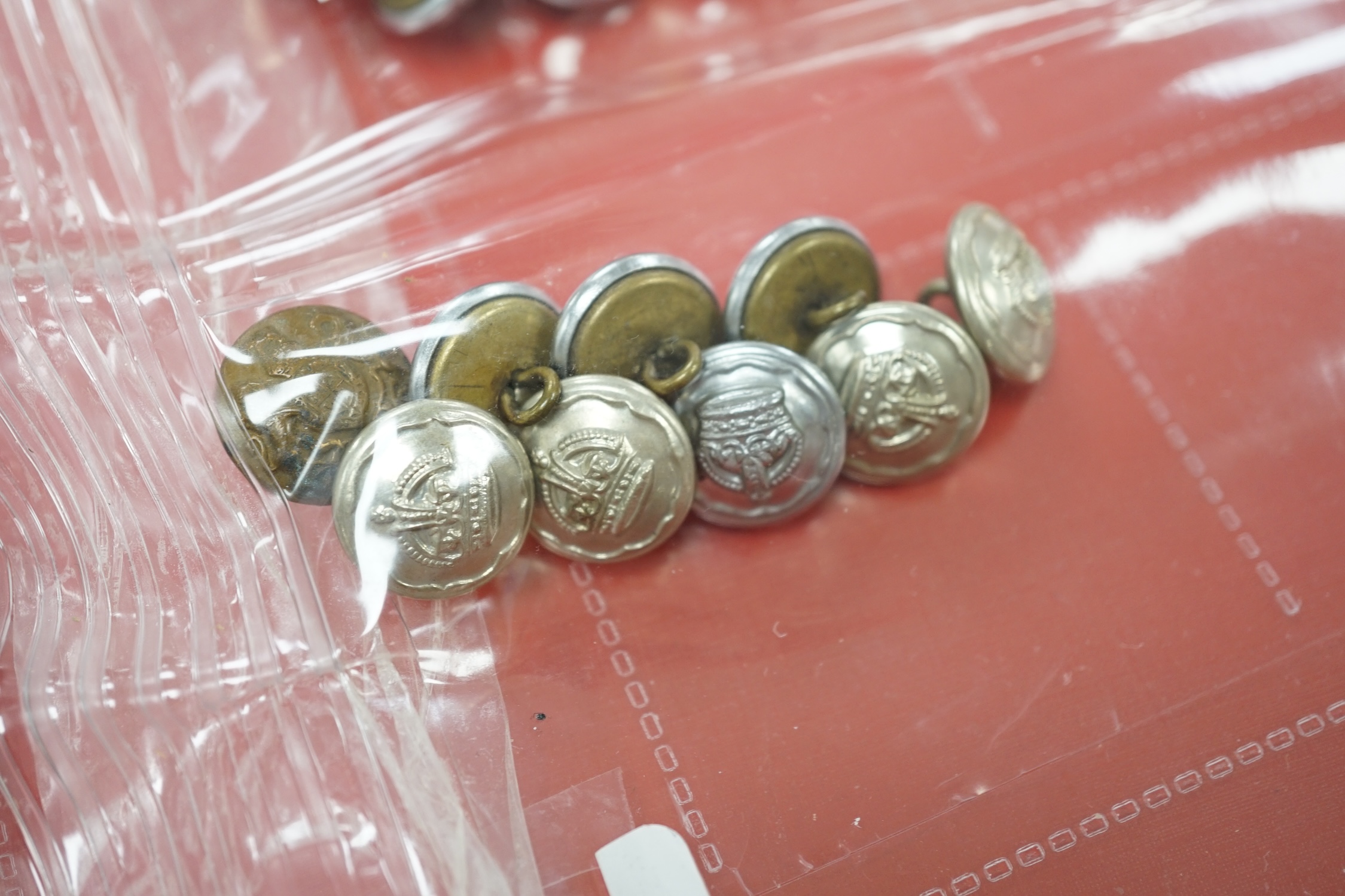 A collection of Police badges and buttons, including to Eastbourne Borough Police helmet plates, Eastbourne Fire Brigade uniform buttons, Royal Navy buttons, a whistle, etc. together with a batten decorated with beadwork